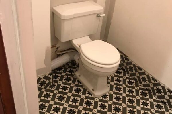 Tiled floor with upstands, fixed unit with sink and fitted toilet #1